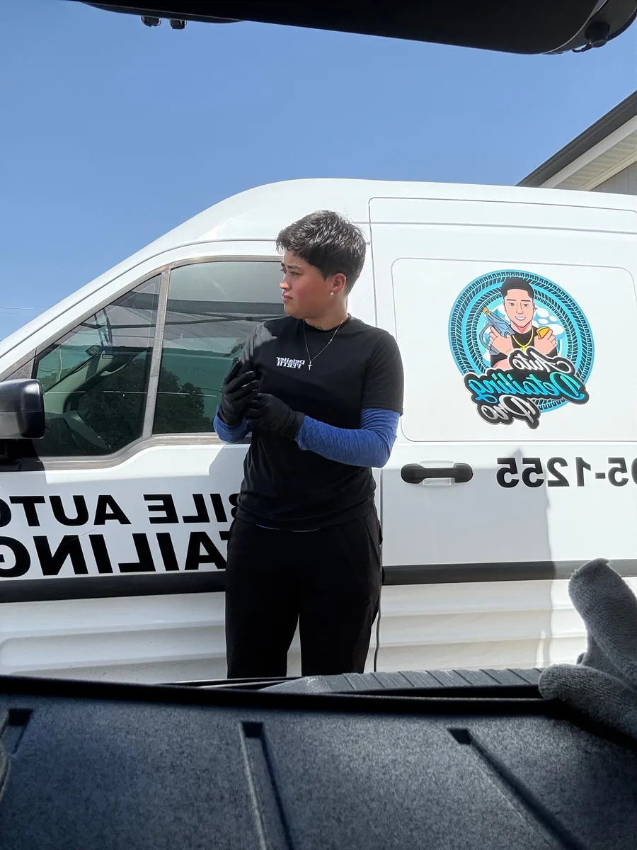 Auto Detailing Pro technician next to the mobile detailing van